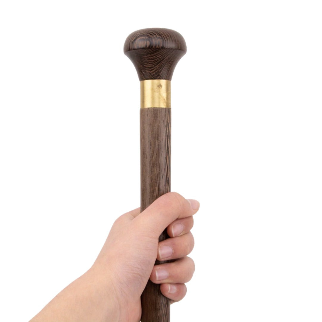 Knob handle walking stick held in the hand
